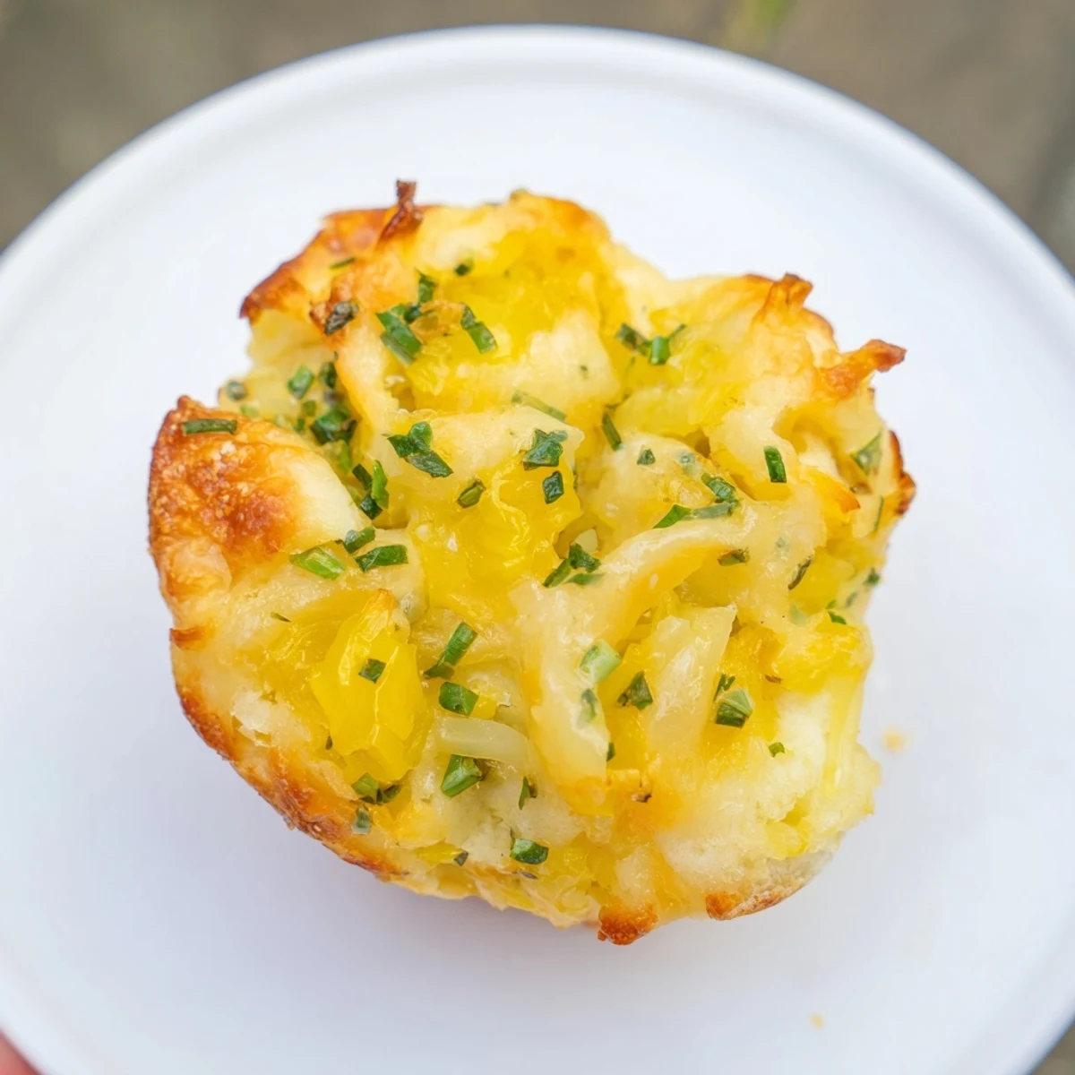 Golden-brown German savoury muffins with melted cheese, perfect for a cozy afternoon snack.