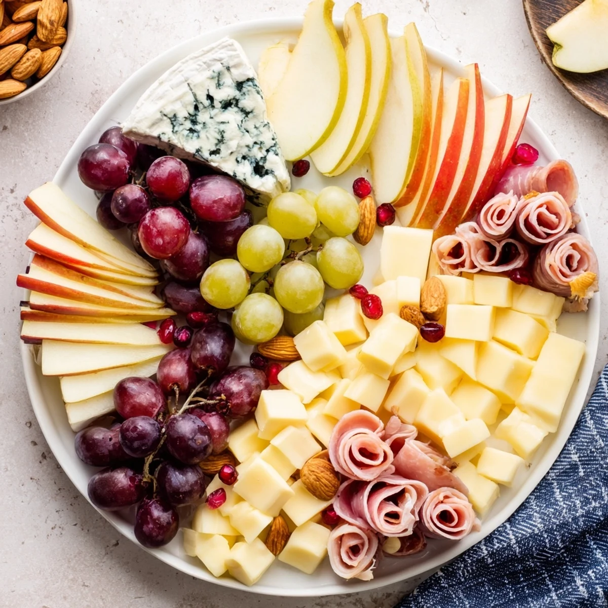 Delicious Winter Wonderland Grazing Tray with an assortment of cheeses, meats, crackers, and festive garnishes.