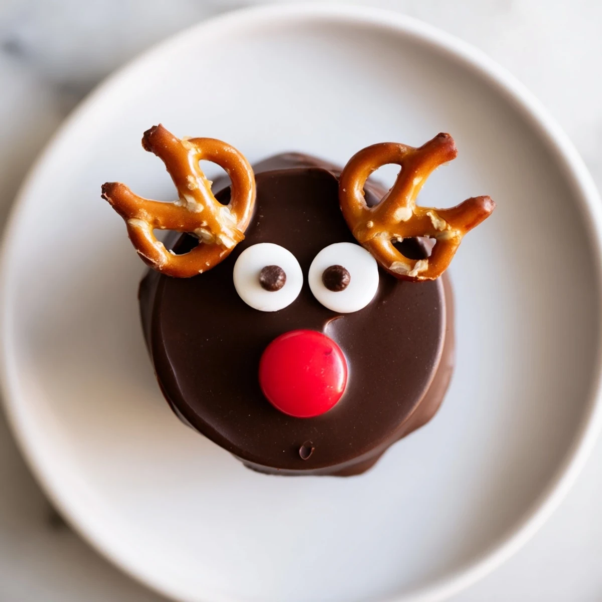 Close-up of chocolate reindeer pudding cups, with festive extras like brownies and marshmallows.