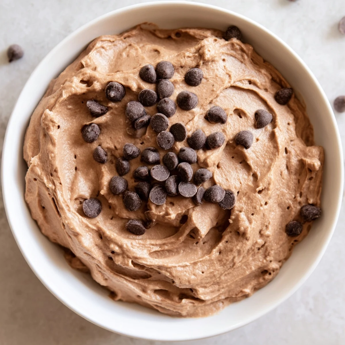 Creamy gluten-free brownie batter dip, perfect for dipping, pictured with fresh strawberries.