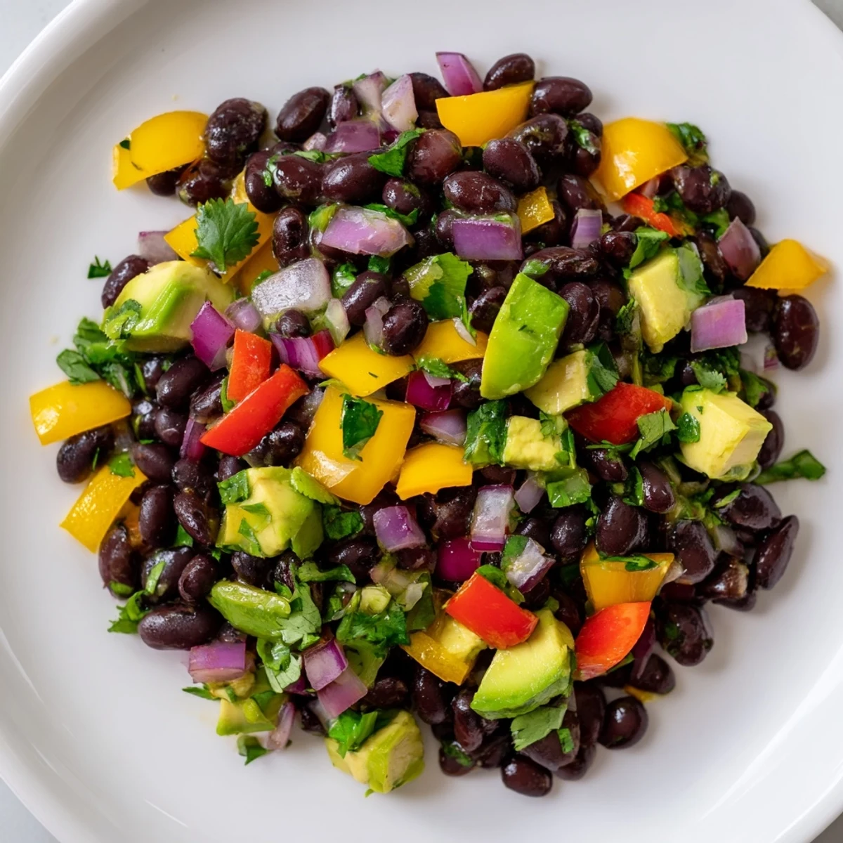 A vibrant Southwest Black Bean Salad, showcasing colorful bell peppers and fresh cilantro with a zesty lime dressing.