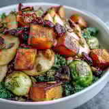 Roasted apples and wilted kale in a hearty Fall Vegetable Bowl with grains.