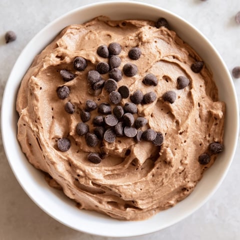 Creamy gluten-free brownie batter dip, perfect for dipping, pictured with fresh strawberries.