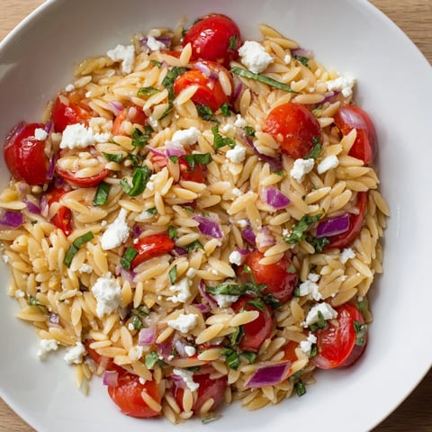 Vibrant Tomato Feta Orzo salad with fresh herbs, a delicious and easy Mediterranean side dish.