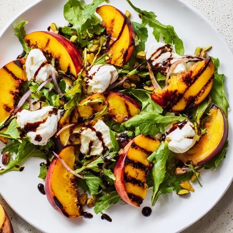 Grilled Peach Salad with charred peaches, creamy burrata, and balsamic glaze makes a flavorful meal.