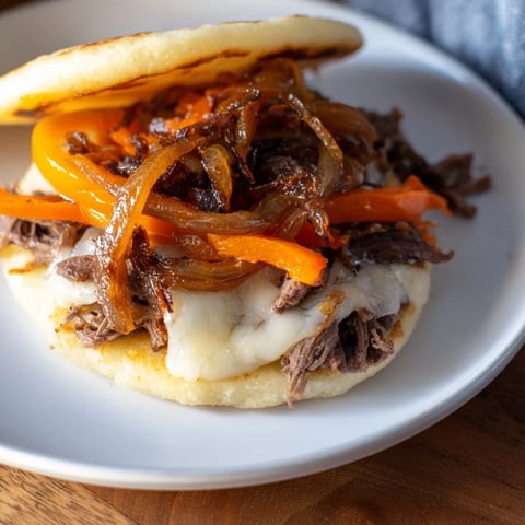 A hearty bowl of Lebanese Mjadra, lentils and rice, topped with glistening golden caramelized onions.